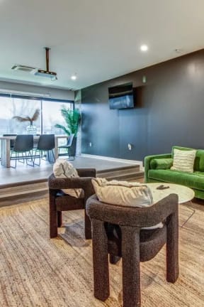 a living room with a green couch and some chairs