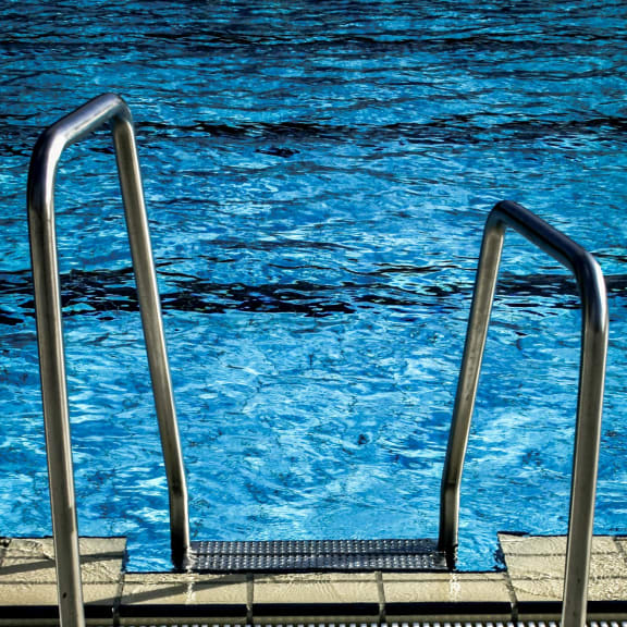 Stylish railings by the poolside, enhancing safety and elegance.