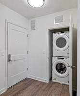 a white laundry room with a washer and dryer in it