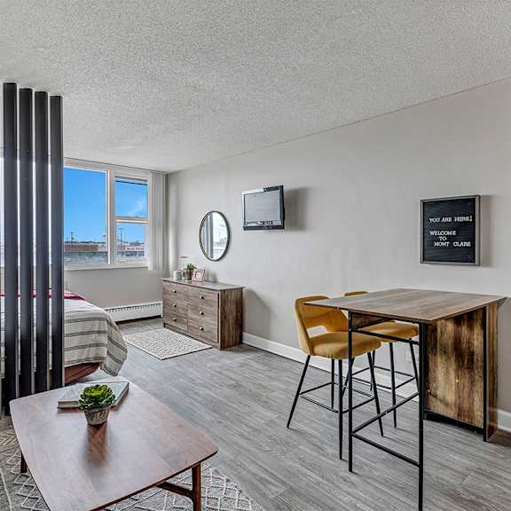 A living room with a brown table and a chair.