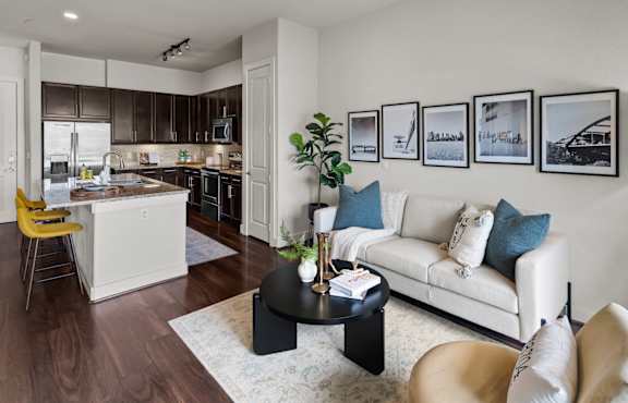 a living room and kitchen with a couch and a table