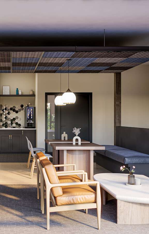 A modern living room with a dining area and kitchen in the background.