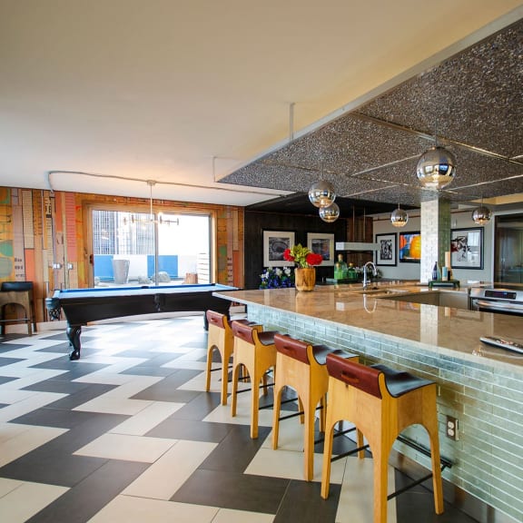 a large kitchen with a bar and a pool table