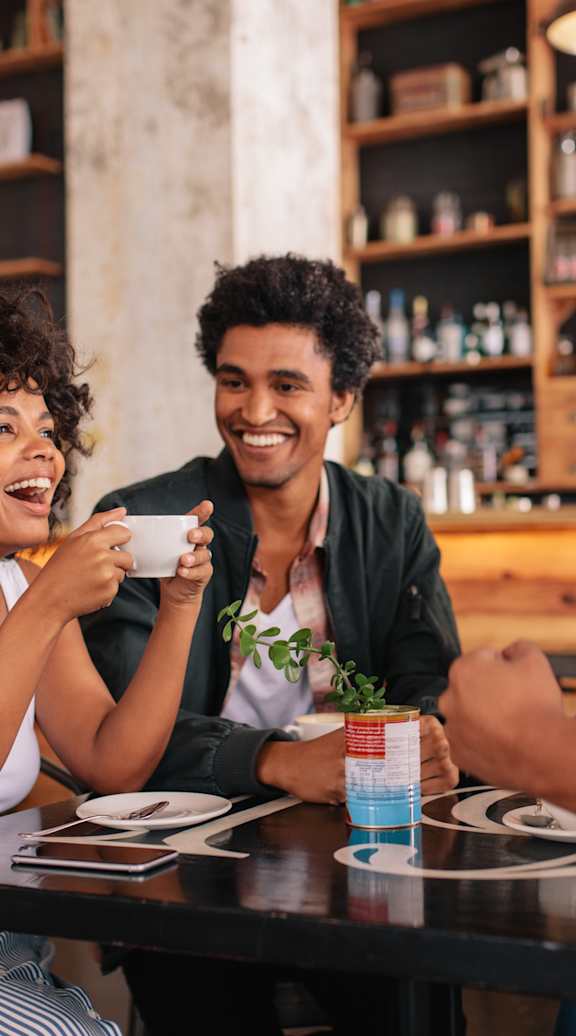 Four people are sitting around a table in a restaurant.