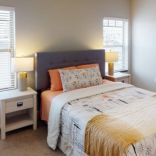 a bedroom with a bed and a window at Upscale Living at the Grand off 45th, Fargo, North Dakota
