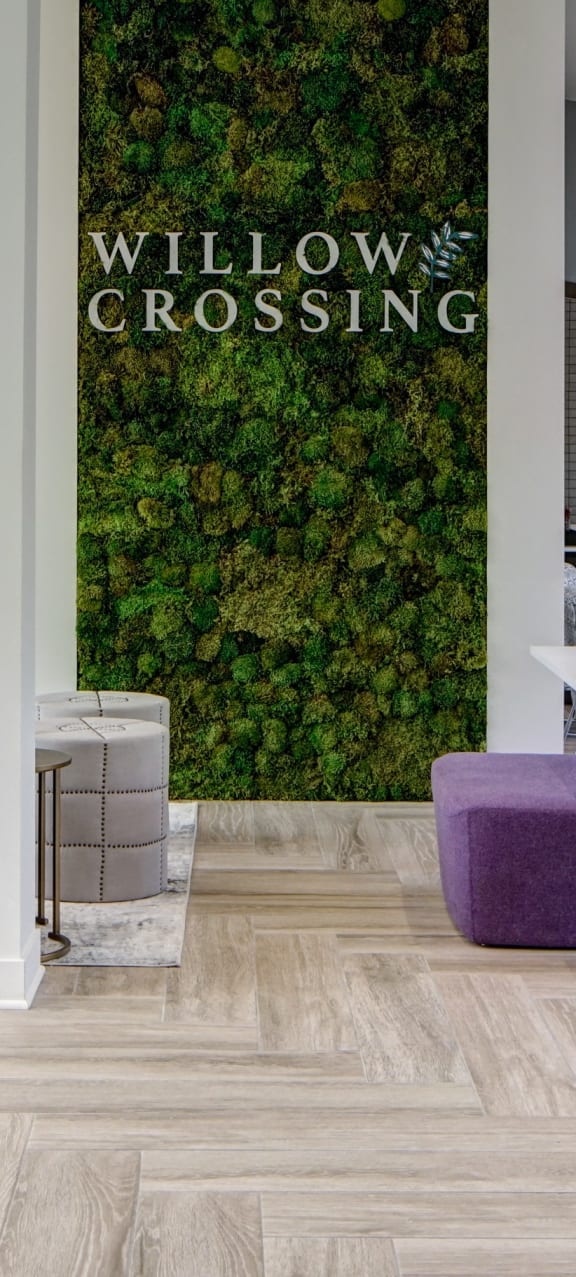 an office with desks and chairs and a green wall on the wall