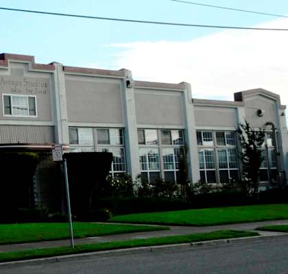 A building with a green sign on the front.