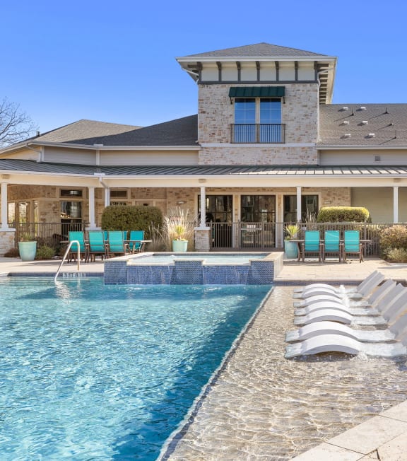 a swimming pool in front of a large apartment building at North Creek, Hutto