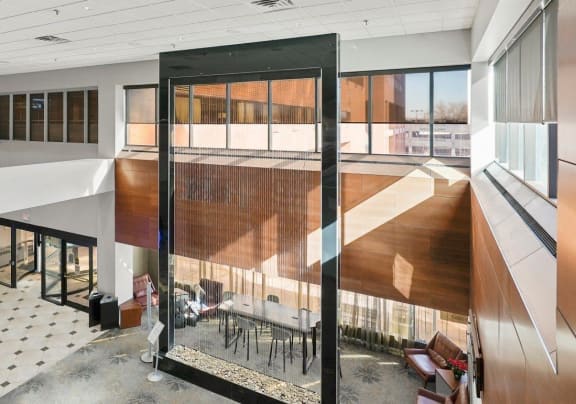 a view of the lobby of a large office building with large windows and arium