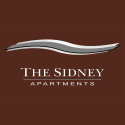 a logo for the sweeney apartments with a wave on top of it