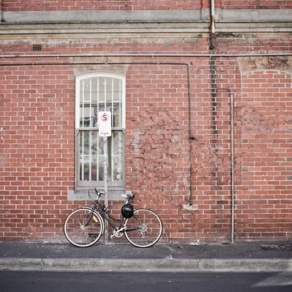 a bike parked in front of a brick building