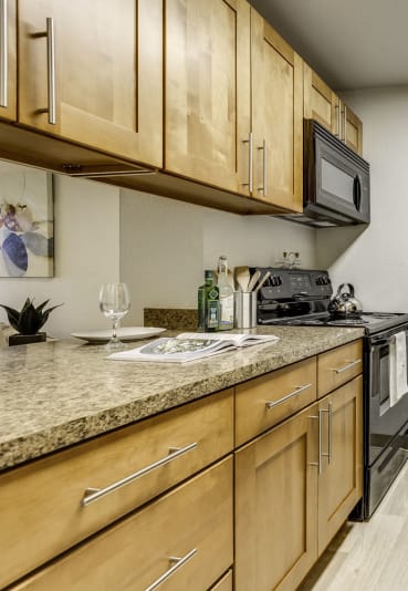 a kitchen with stainless steel appliances and wooden cabinets