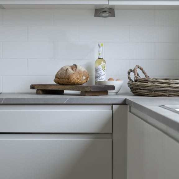 a loaf of bread on a cutting board on top of a kitchen counter