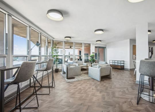 a living room with tables and chairs and a balcony