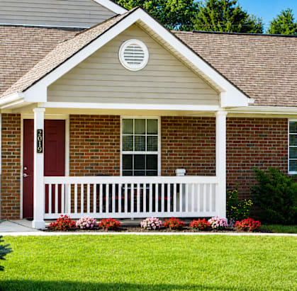 A house with a red door and white porch.