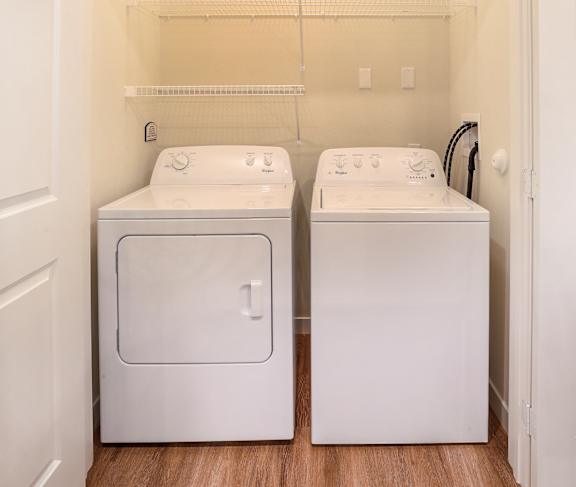 A small laundry room with a washer and dryer.