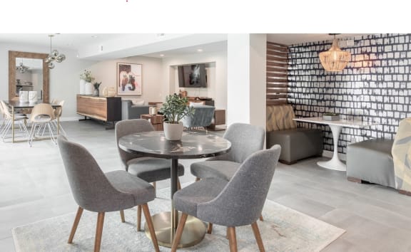 a living room and dining room with a table and chairs