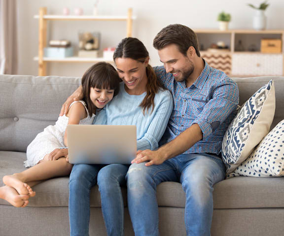 Young Family on Laptop at Vista Ridge Apartments, Phoenix, 85041
