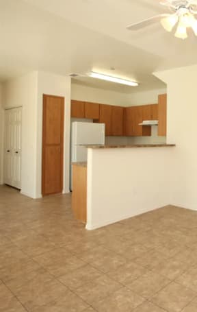 Empty room with a ceiling fan and tiled floor.