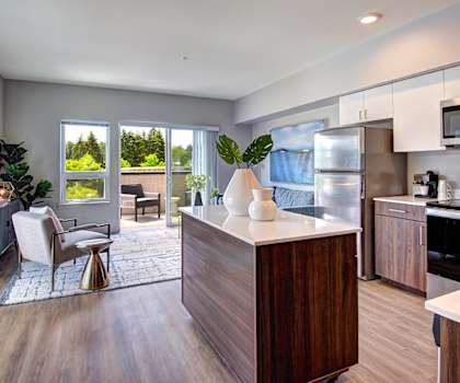 an open kitchen and living room with a view of a patio