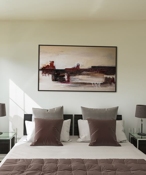 a bedroom with a bed with pillows and two lamps at Horace Mann apartments and townhomes in Gary, IN