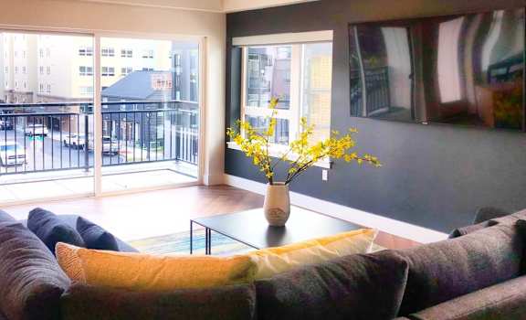 a living room with a couch and a glass table