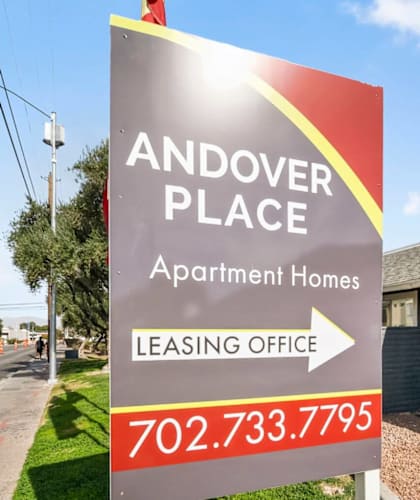 A sign for Andover Place Apartment Homes with a leasing office phone number.