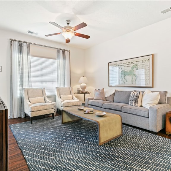 a living room with a couch and a ceiling fan