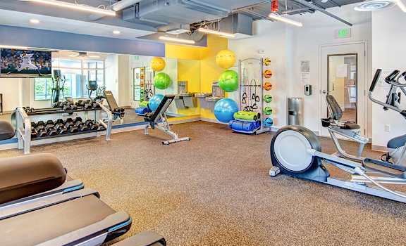 a gym with treadmills and other exercise equipment at the enclave at university crossings