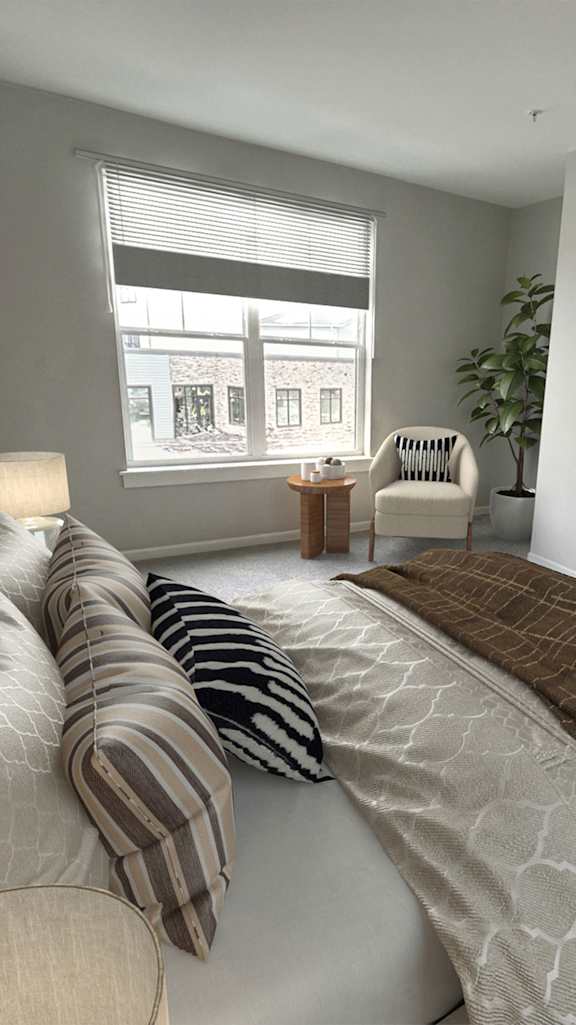 A room with a bench, picture, and framed objects on the wall.