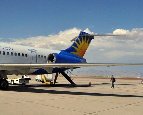 a fighter jet sitting on top of an airport runway