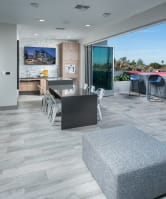 a dining area with tables and chairs and a bar with a view
