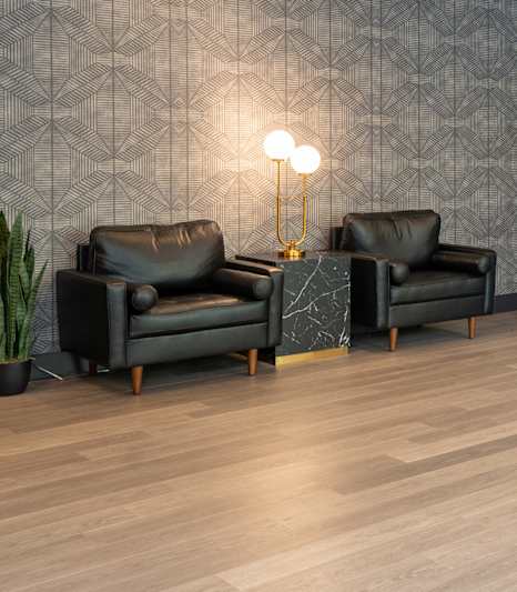 A modern lounge area with a long table and chairs.