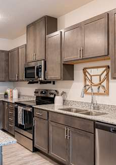 a kitchen with stainless steel appliances and granite counter tops