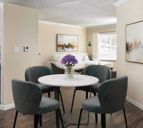 a living room and kitchen with a table and chairs