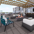 A patio with a fireplace, a chair, and a couch.