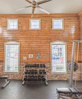 the gym at 1861 muleshoe road has a lot of exercise equipment and windows