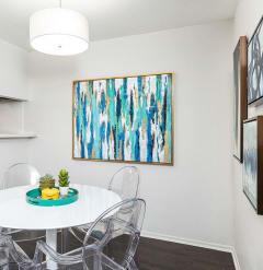 a dining room with a white table and chairs