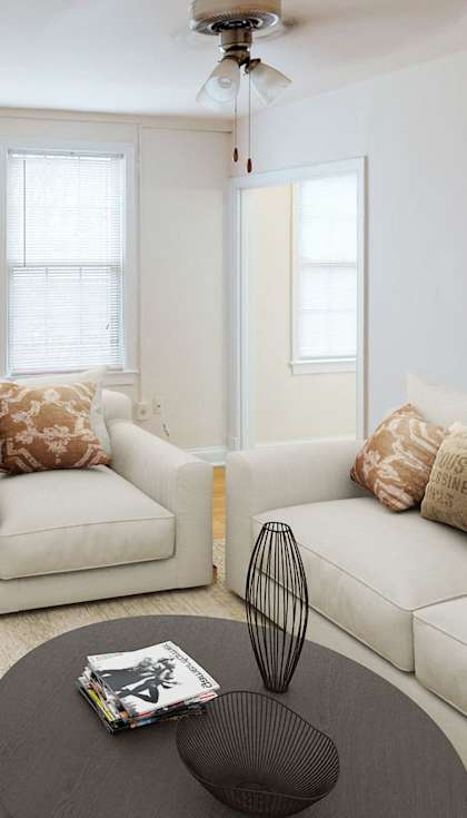 a living room with a couch and a chair and a tv