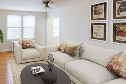 a living room with a couch and a chair and a tv