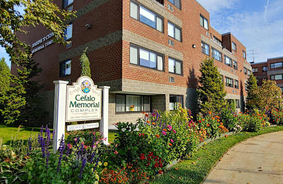 The Cefalo Memorial complex is a large brick building with a landscaped garden in front.