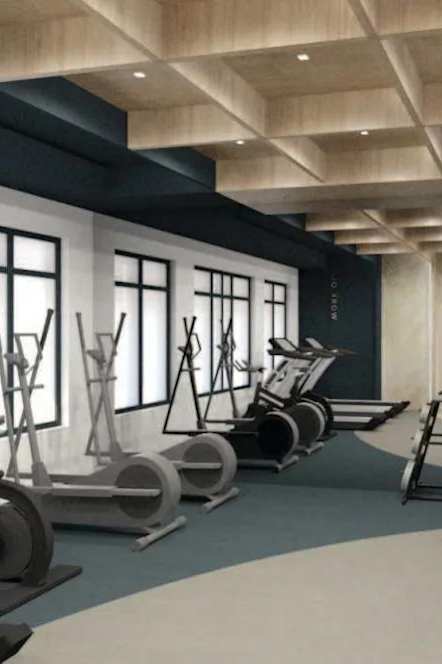 a gym with a lot of equipment and windows at Ardenwood Apartments, North Haven