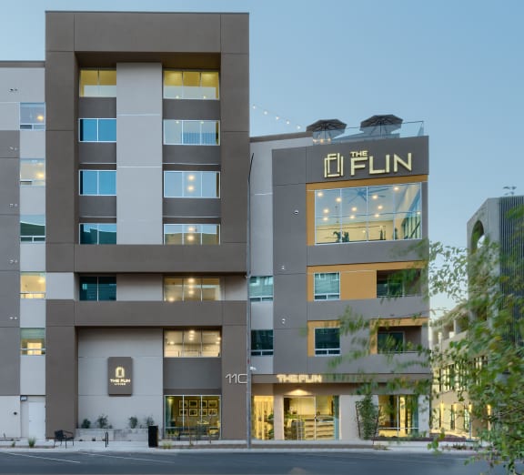 a building with a cactus garden in front of it