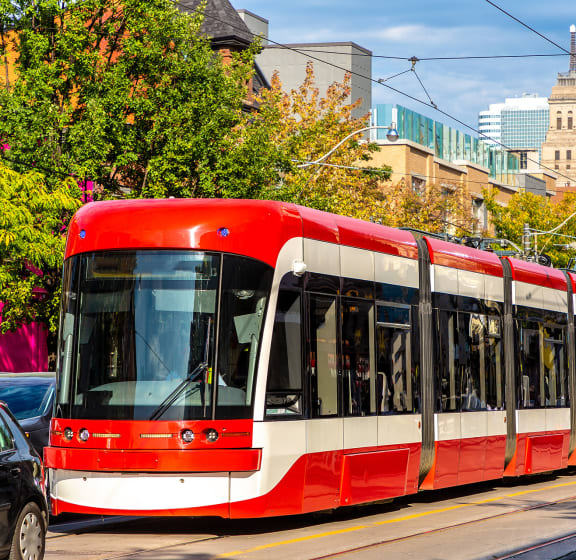 a red and white streetcar on a city street