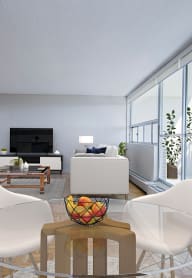 a living room with a white couch and blue chairs and a coffee table in front of a