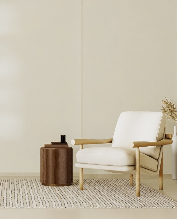 a living room with a chair and a side table