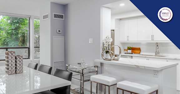 A modern kitchen with a dining table and chairs.