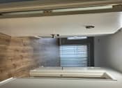 Thumbnail 14 of 18 - A room with a white table and a wooden wall.