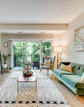 A living room with a green couch and a coffee table.