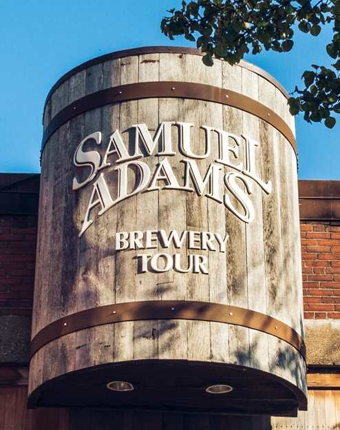 A Samuel Adams Brewery Tour sign is displayed on a building.
